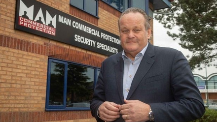 Iain headshot outside office.jpg