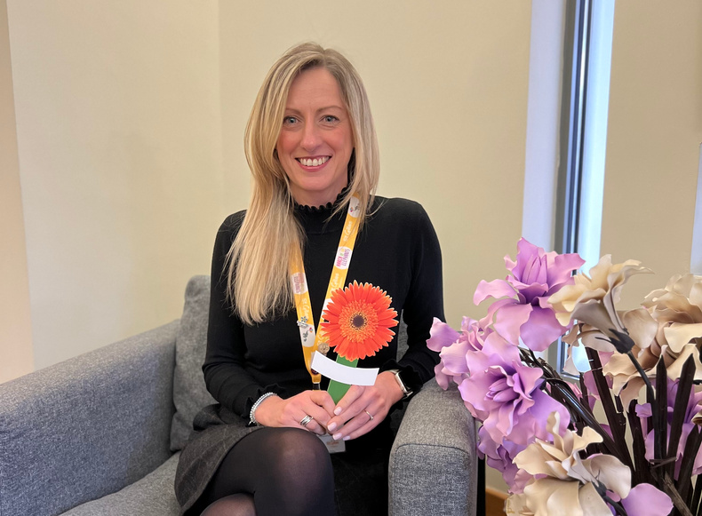 Ali Callear, Community and Family Services Practitioner at St Giles Hospice, holding a Celebrate Lives Lived Gerbera peg.jpg