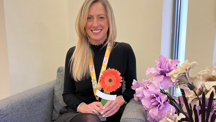 Ali Callear, Community and Family Services Practitioner at St Giles Hospice, holding a Celebrate Lives Lived Gerbera peg.jpg