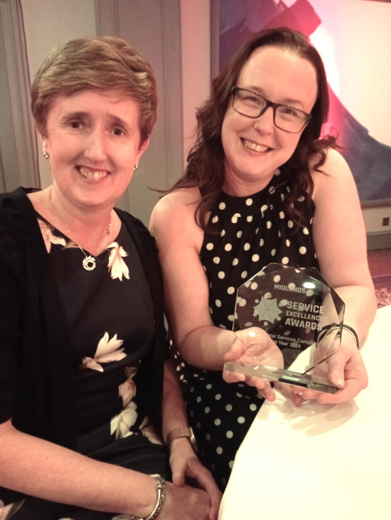 Sharon Bell (left) with Sarah Caldwell and the award.jpg